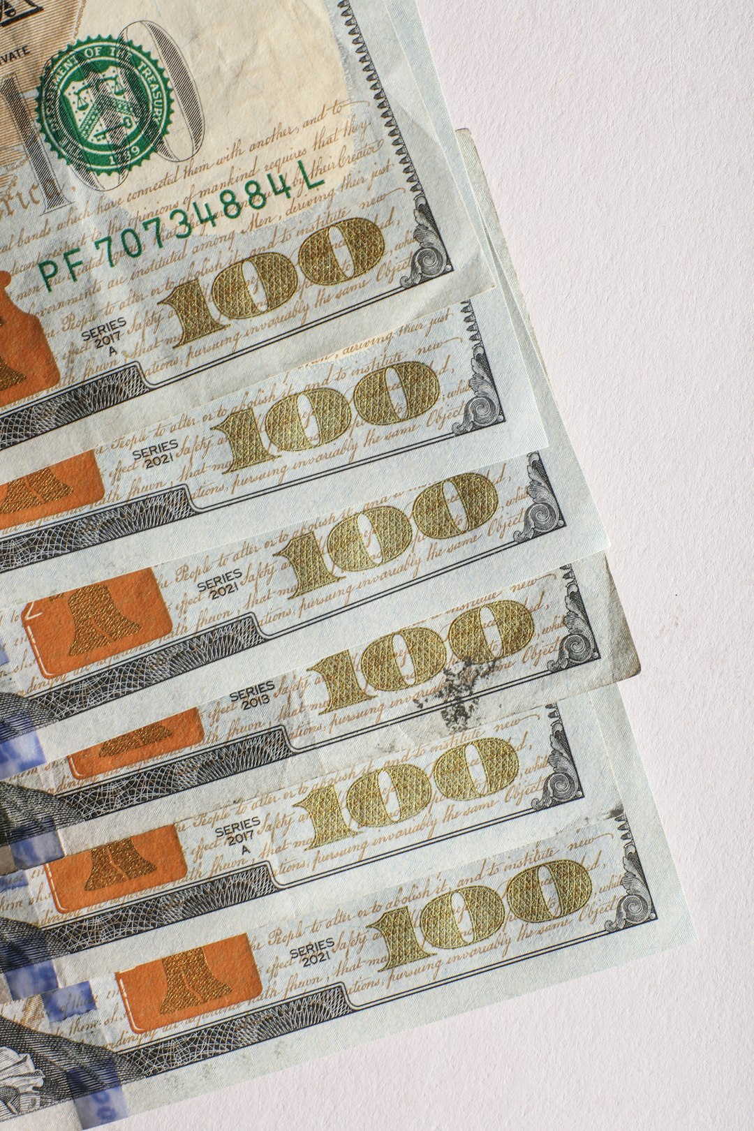 several-us-hundred-dollar-bills-fanned-out-cx-ioe3pdo0