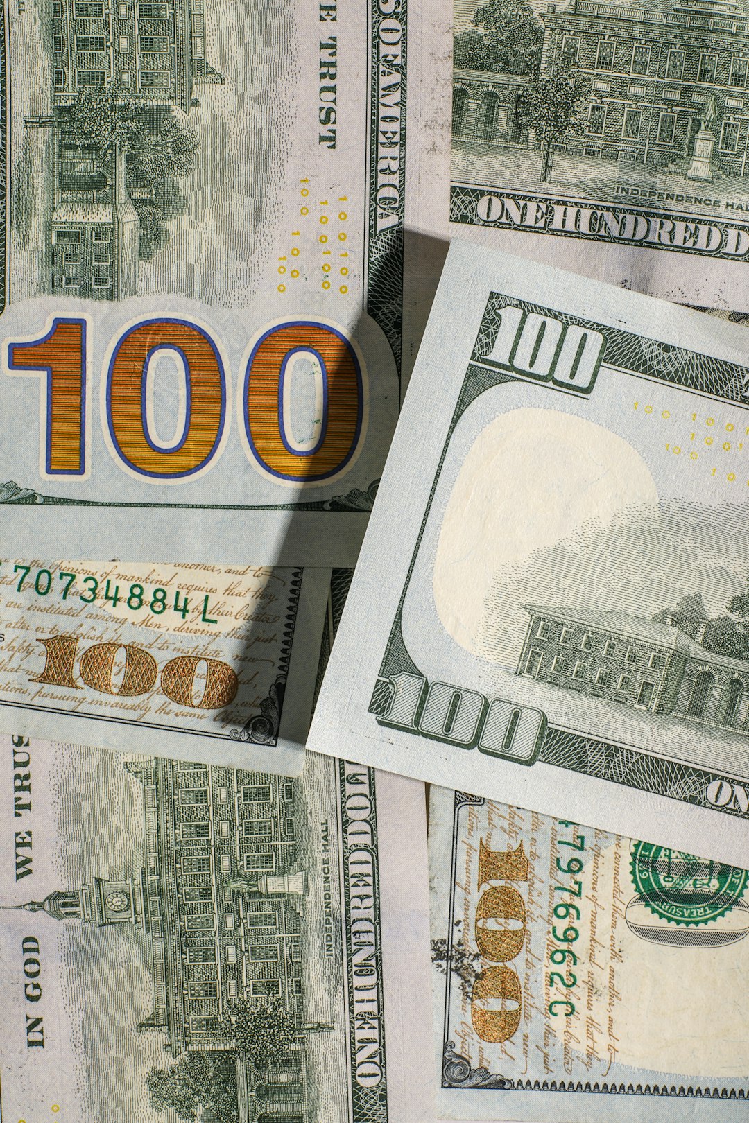 one-hundred-dollar-bills-spread-out-ld19p-tjlgk